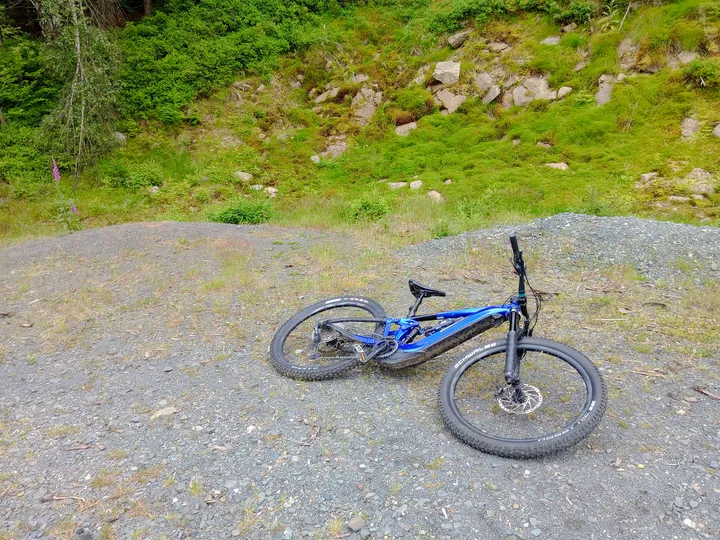 Bicycle laid beside the gravel surface at Izera Mountains cycling trail