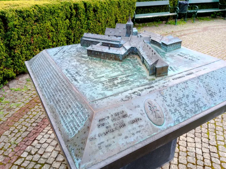 A tactile city model beside the planting at Jacek Woźniakowski Square