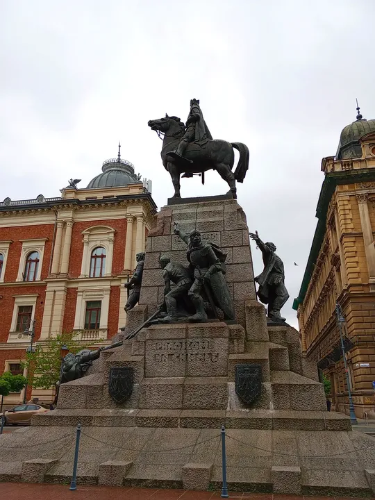 Monument seen above the nearby roofline at Jan Matejko Square