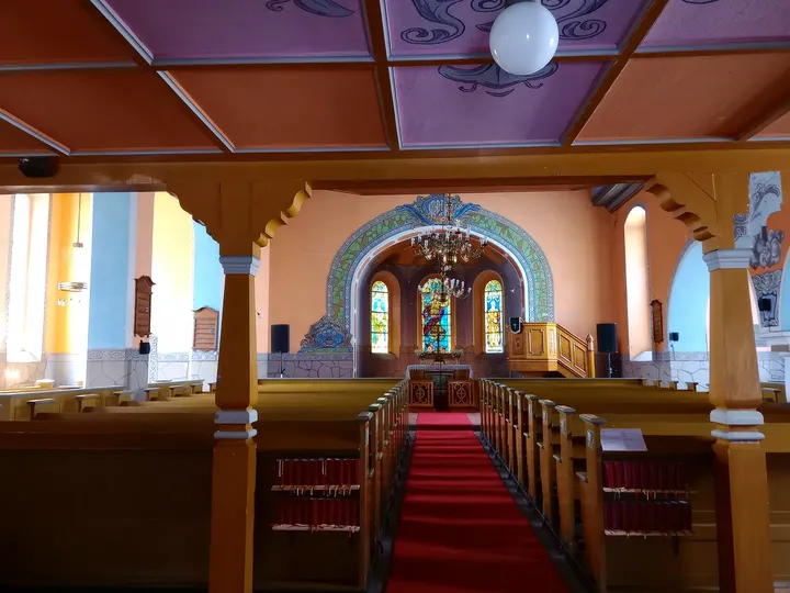 Pews beneath the coloured ceiling at Jesus Church, Zielona Góra