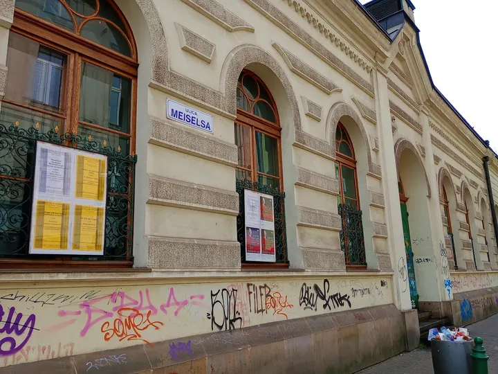 Posters beneath the arched windows at Jewish Culture Centre, Kraków