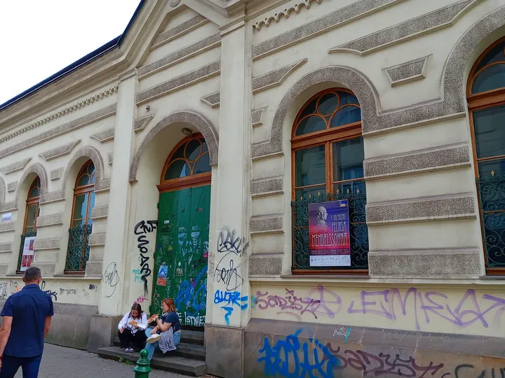 Arched windows and programme notices at Jewish Culture Centre, Kraków
