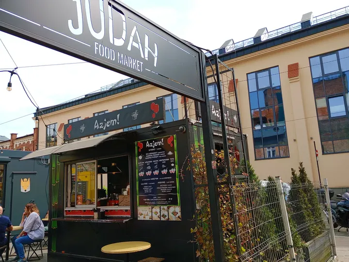 Signs above the food stalls at Judah mural