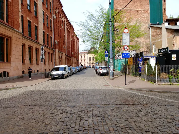 A cobbled street beside the courtyard at Judah mural