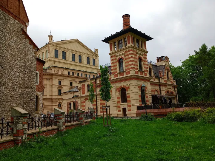 The brick building beside the garden at Juliusz Słowacki Theatre