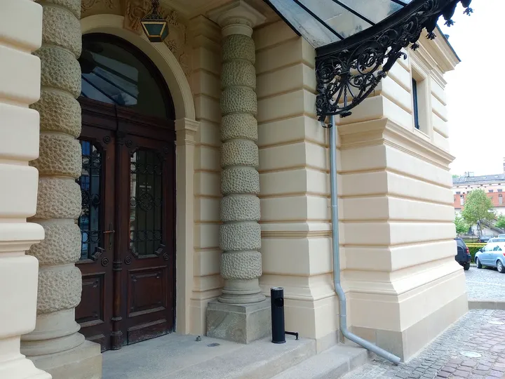 The stone entrance and carved doors at Juliusz Słowacki Theatre