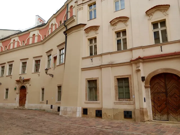 Pale townhouses with carved window surrounds at Kanonicza Street