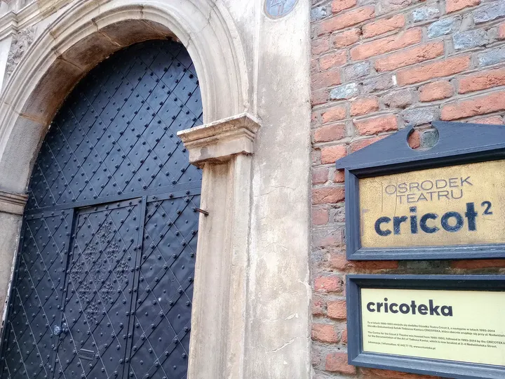 Older doorway beside an exhibition notice at Kanonicza Street
