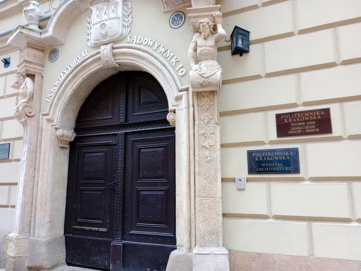 Arched doorway and commemorative plaques at Kanonicza Street