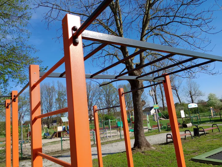 Black overhead rungs on the orange frame at Kiełpin outdoor exercise ground