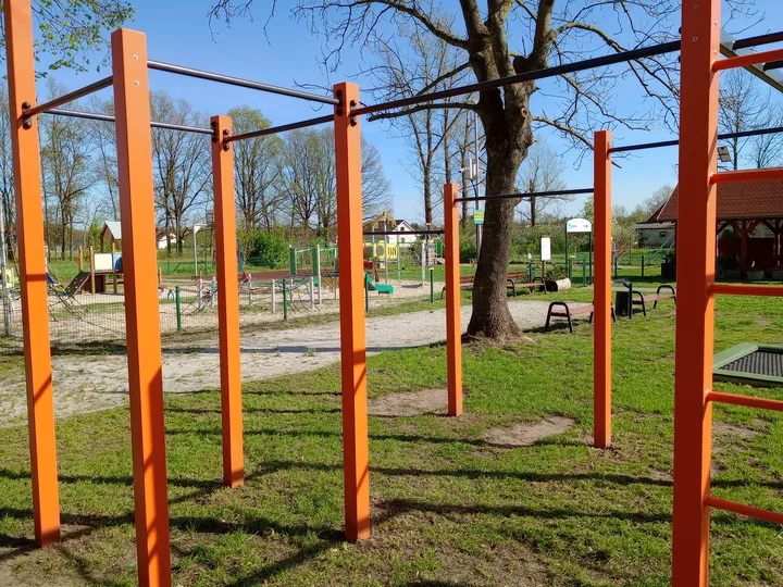 Multiple stations beside the village buildings at Kiełpin outdoor exercise ground