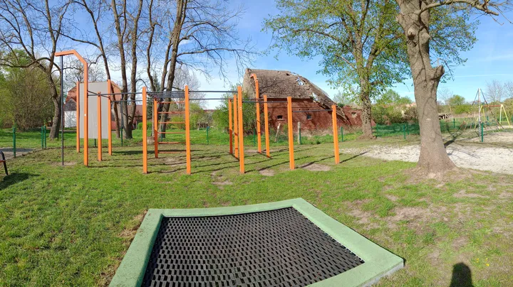 Orange exercise frames beside the path at Kiełpin outdoor exercise ground