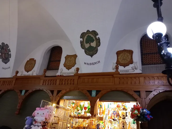 Decorative shields above the stalls at Kraków Cloth Hall