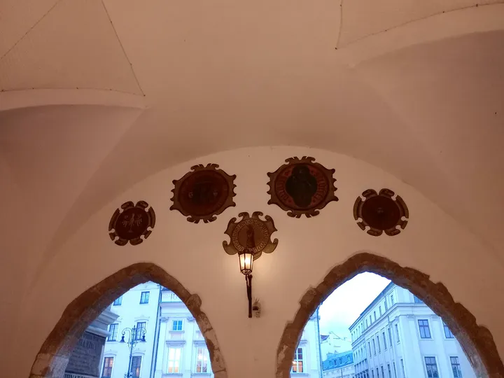 Upper windows and heraldic decoration at Kraków Cloth Hall