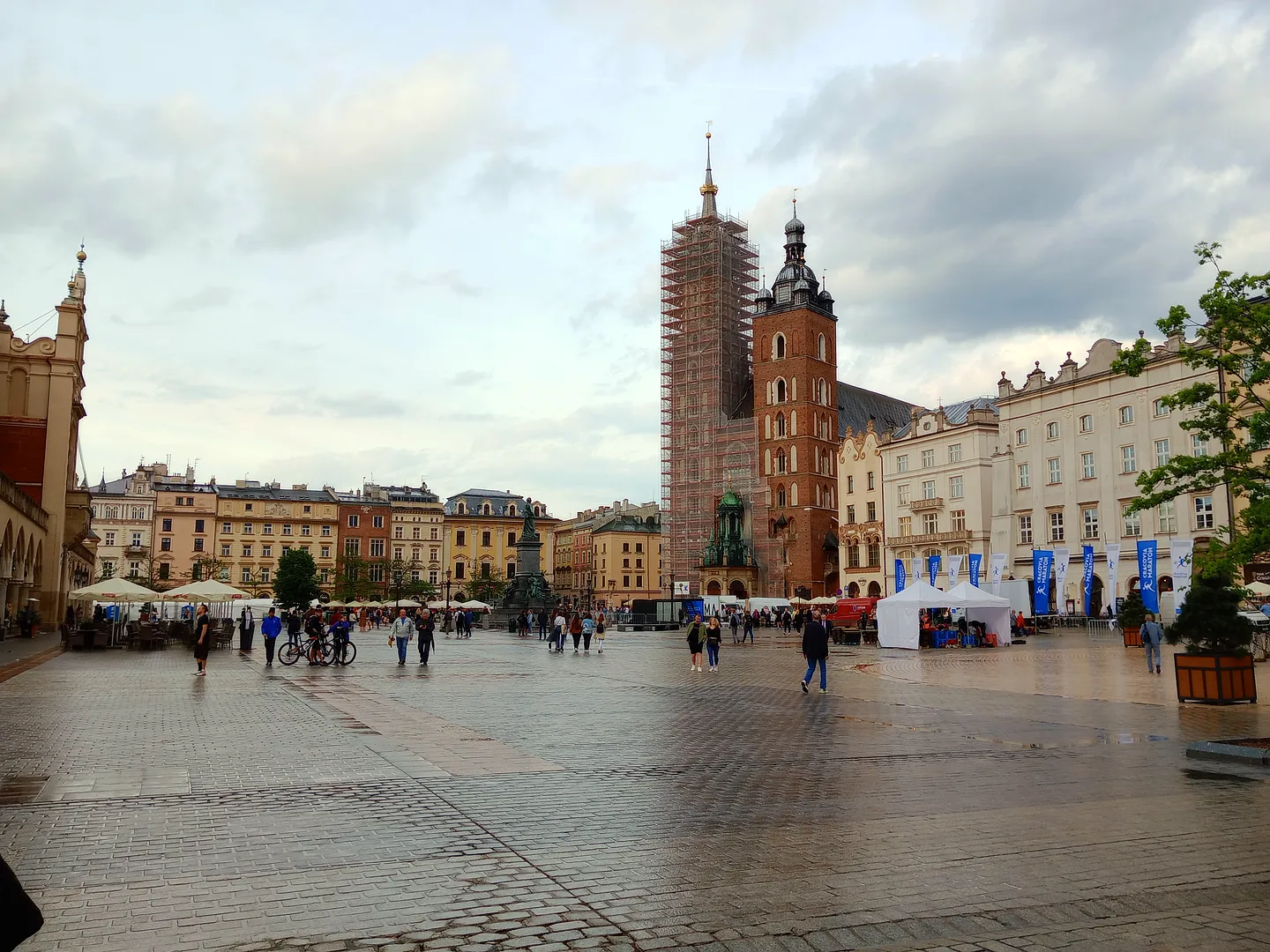 The Town Hall Tower across the wet square at Kraków Main Market Square
