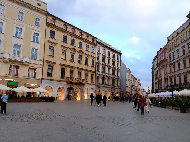 Café frontages beside a street opening at Kraków Main Market Square