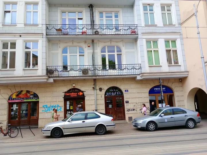 Shop windows beneath the upper balconies at Krakowska Street