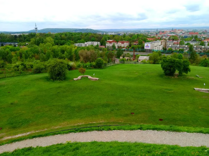 Open grass and distant townhouses at Krakus Mound