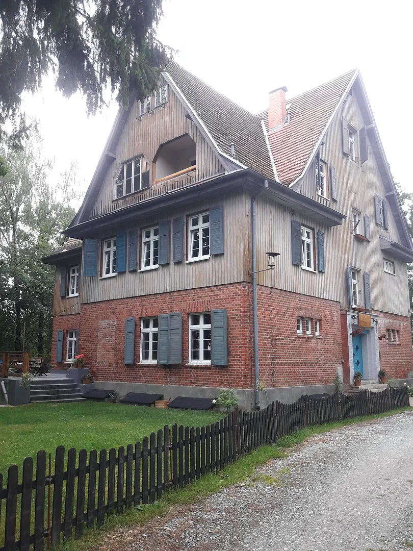 An older house behind its garden fence at Lecha neighbourhood, Łagów