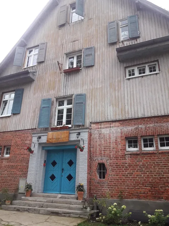 The painted lower façade and entrance at Lecha neighbourhood, Łagów