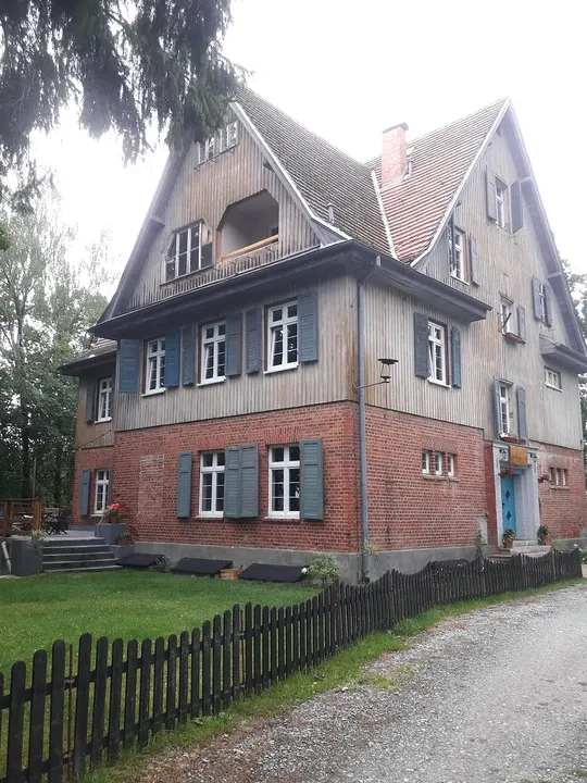 An older house behind its garden fence at Lecha neighbourhood, Łagów