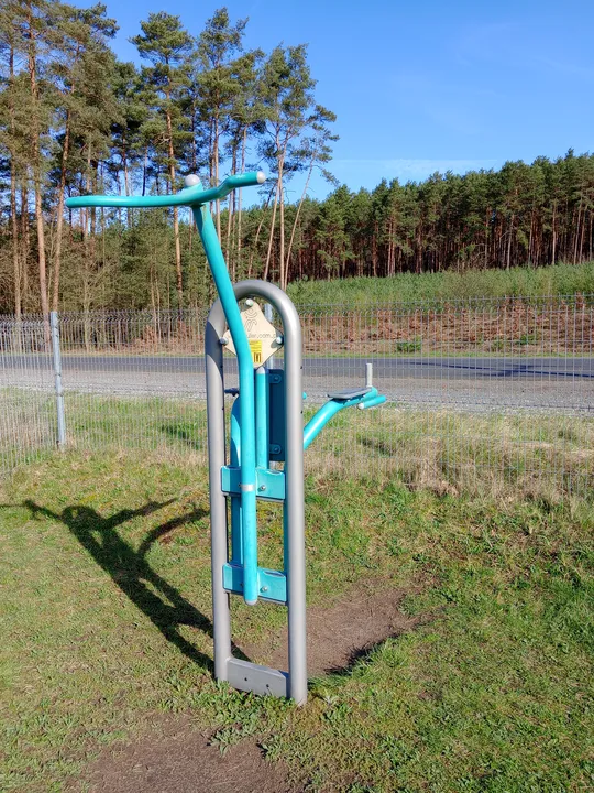 Equipment beside the bare trees at Łężyca outdoor exercise ground