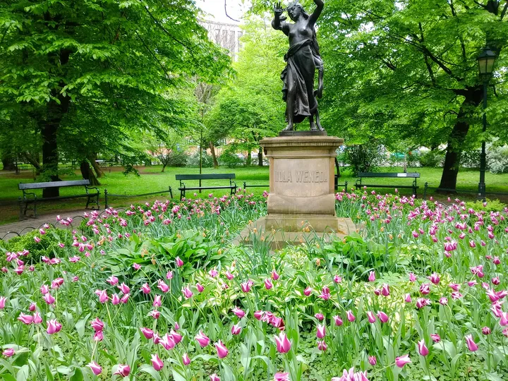 Tulips beneath the sculpted figure at Lilla Weneda monument