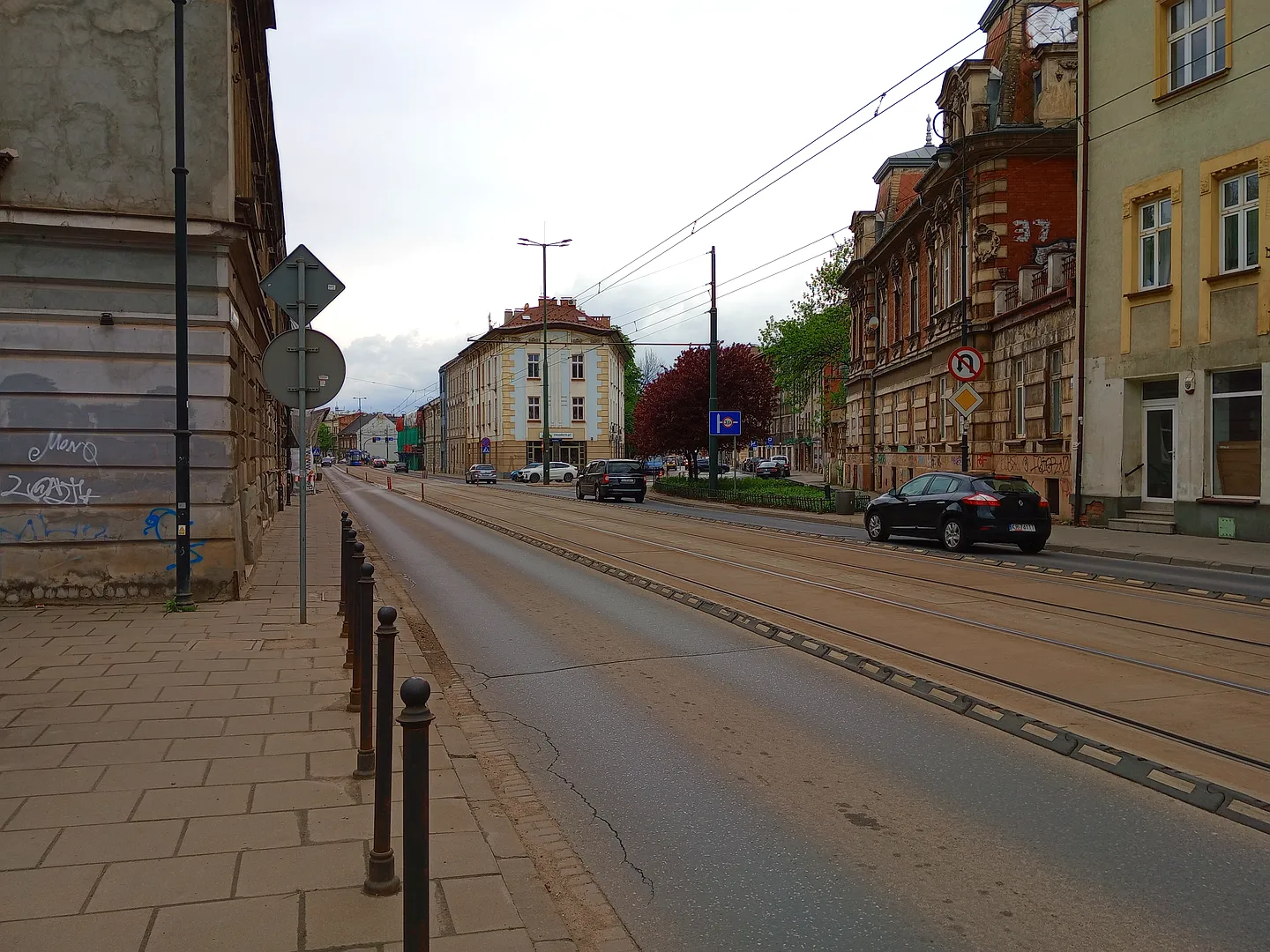 The roadway and buildings along the street at Limanowskiego Street