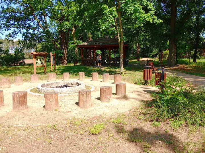 Timber seats around the circular gathering area at Manor Park, Kiełpin