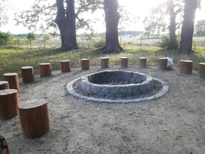 Circular fire area with timber seats at Manor Park, Kiełpin