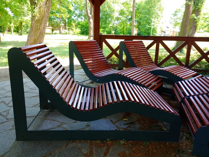 Curved benches within the shelter at Manor Park, Kiełpin