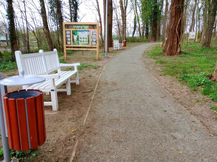 Bench beside another educational board at Manor Park, Świdnica