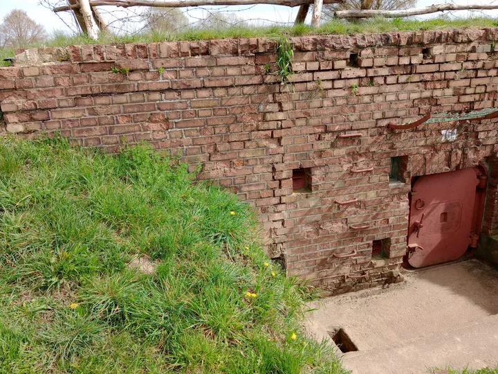 Concrete structure below the grassy bank at Międzyrzecz Fortified Region