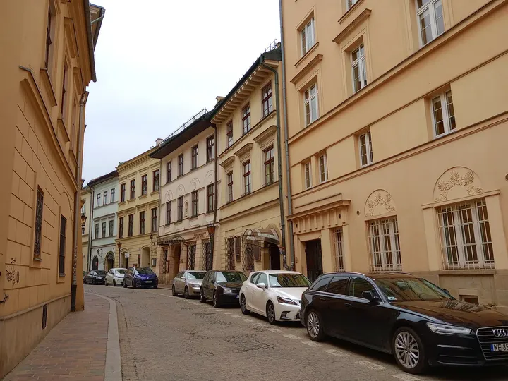 The street’s row of older townhouses at Mikołajska Street