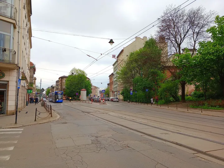 The street continuing beyond the crossing at Miodowa Street