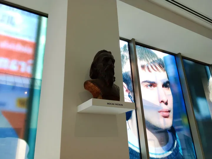 Exhibition notices behind glass at MOCAK contemporary art museum