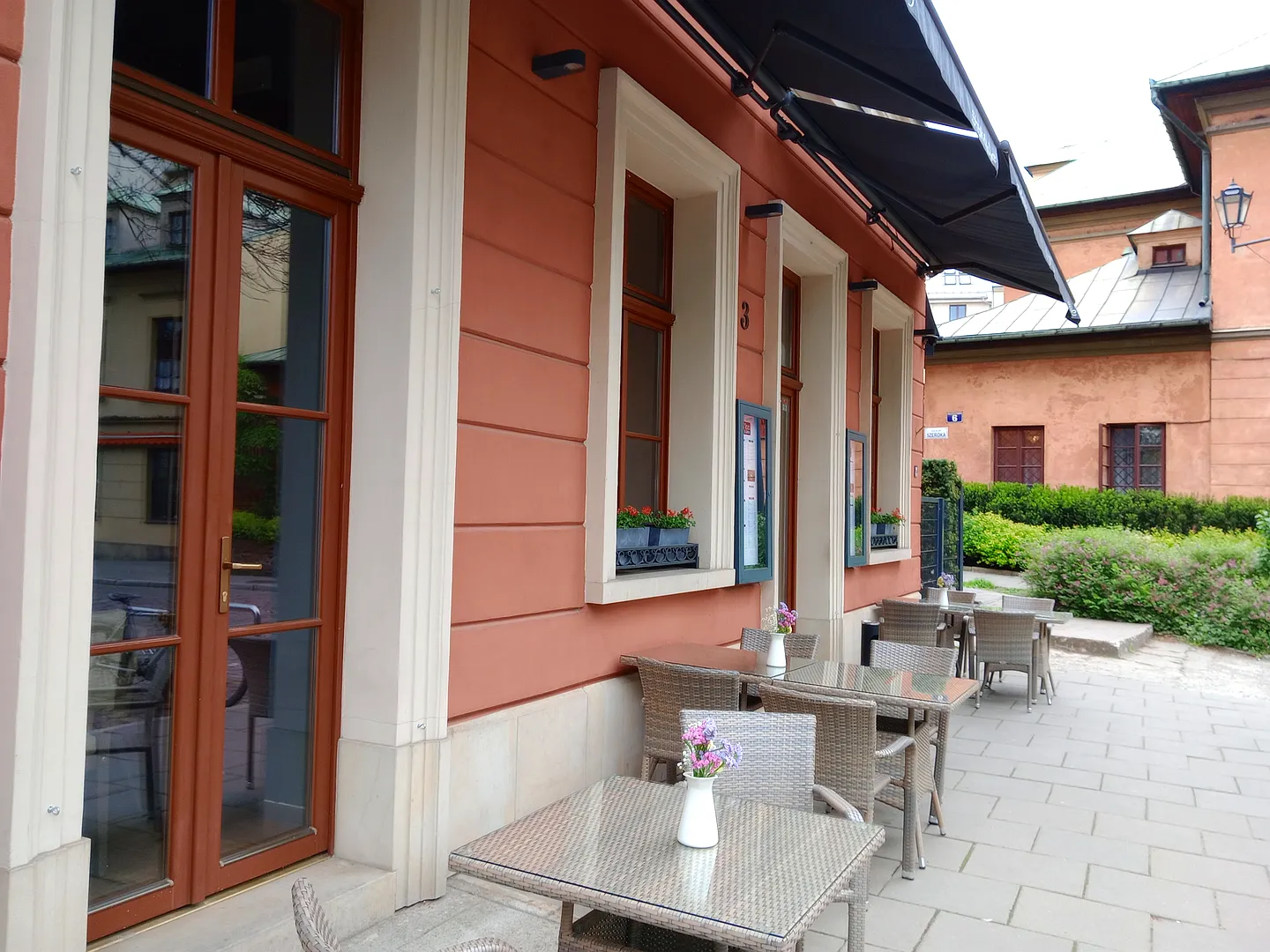 Restaurant entrance and outside tables at Moo Moo