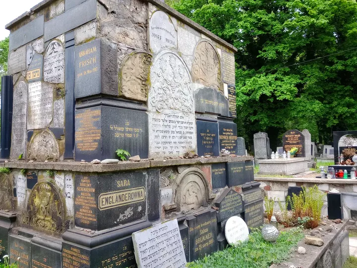 A stone memorial among the graves at New Jewish Cemetery, Kraków