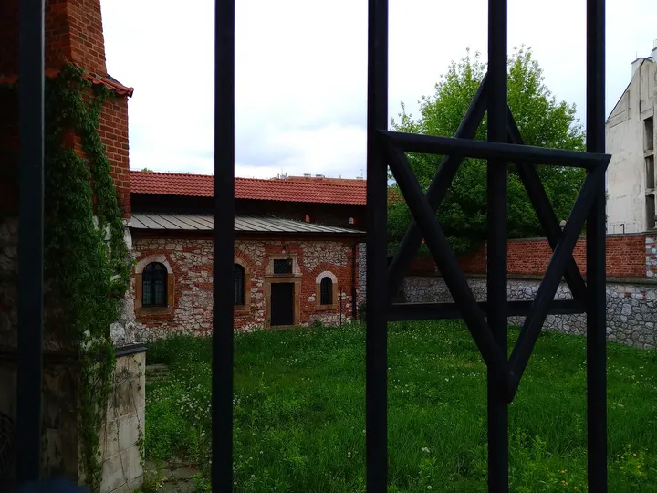 The wall seen through the railing at Old Synagogue, Kraków