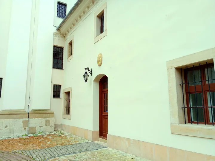 The pale church wall beside the courtyard at Our Lady of the Snows Church, Kraków