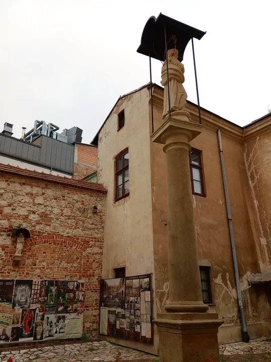 A bell beside the courtyard wall at Our Lady of the Snows Church, Kraków