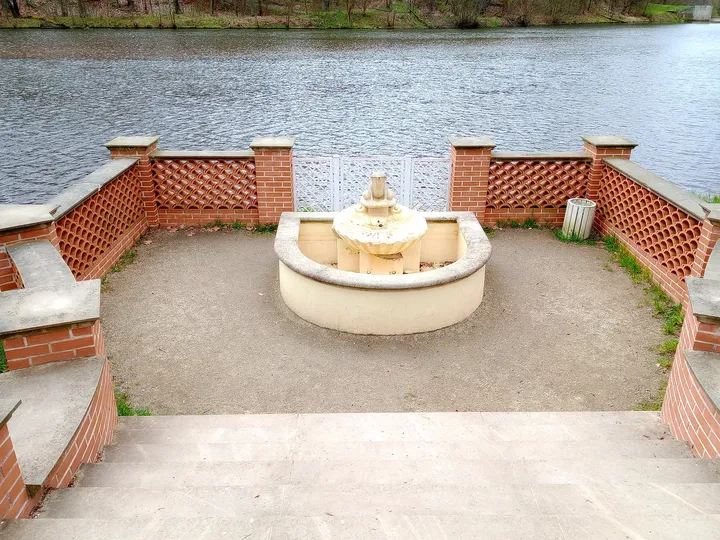Small fountain within its enclosure at Palace Park, Żagań