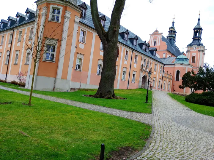 The monastery building beside the paved path at Paradyż monastery and seminary