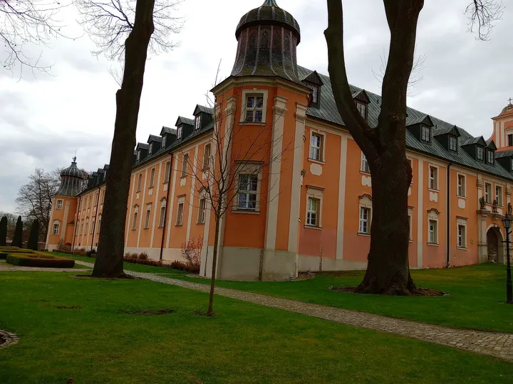 The towers above the long brick façade at Paradyż monastery and seminary