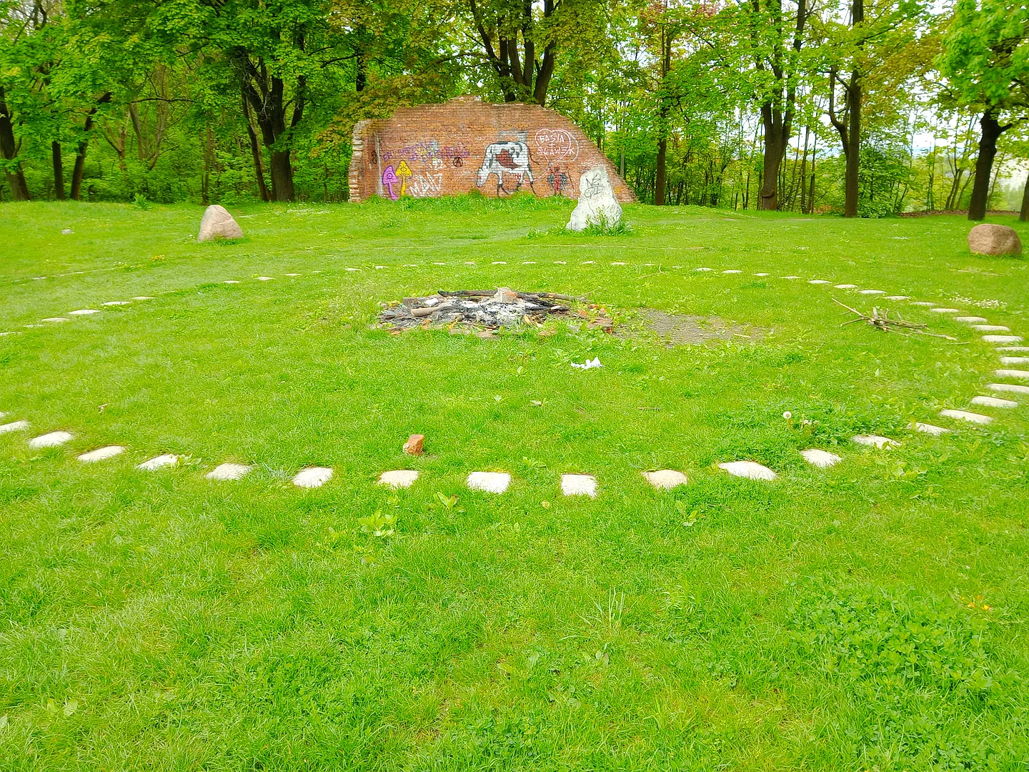 Circular arrangement on the grass at Peace Bells Garden, Kraków