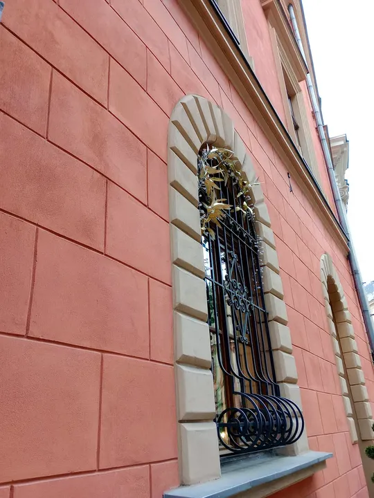 Decorative grille across a window at Pijarska Street
