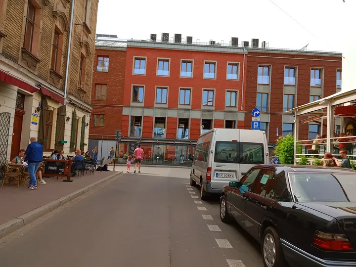 Parked vehicles on the adjoining street at Plac Izaaka street food square