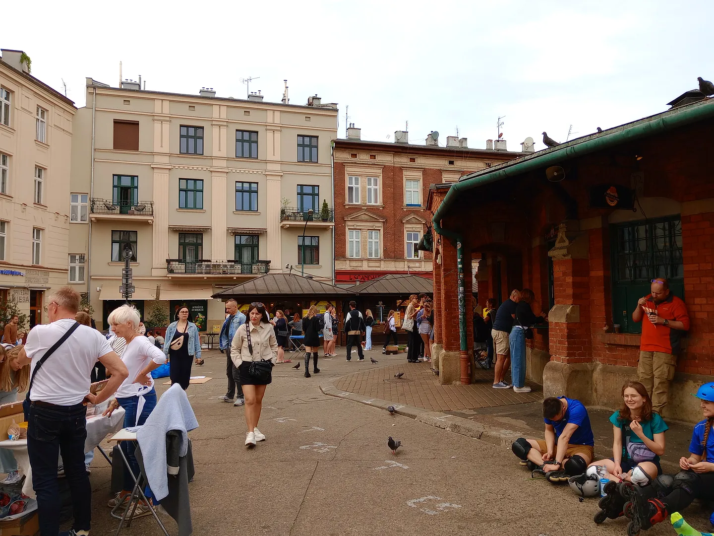People around the round market building at Plac Nowy, Kazimierz