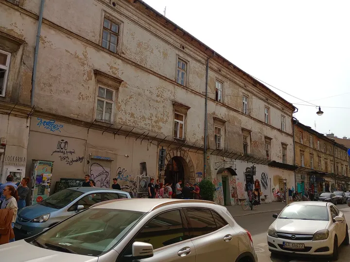 Parked cars beside an old wall at Plac Nowy, Kazimierz