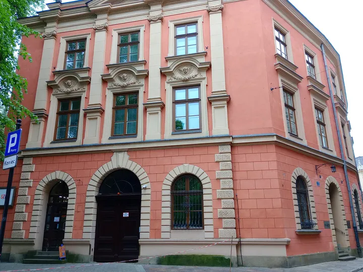 A red corner building near the garden at Planty beside Pijarska Street